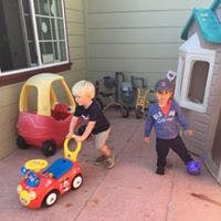 Two children playing with toys outdoors
