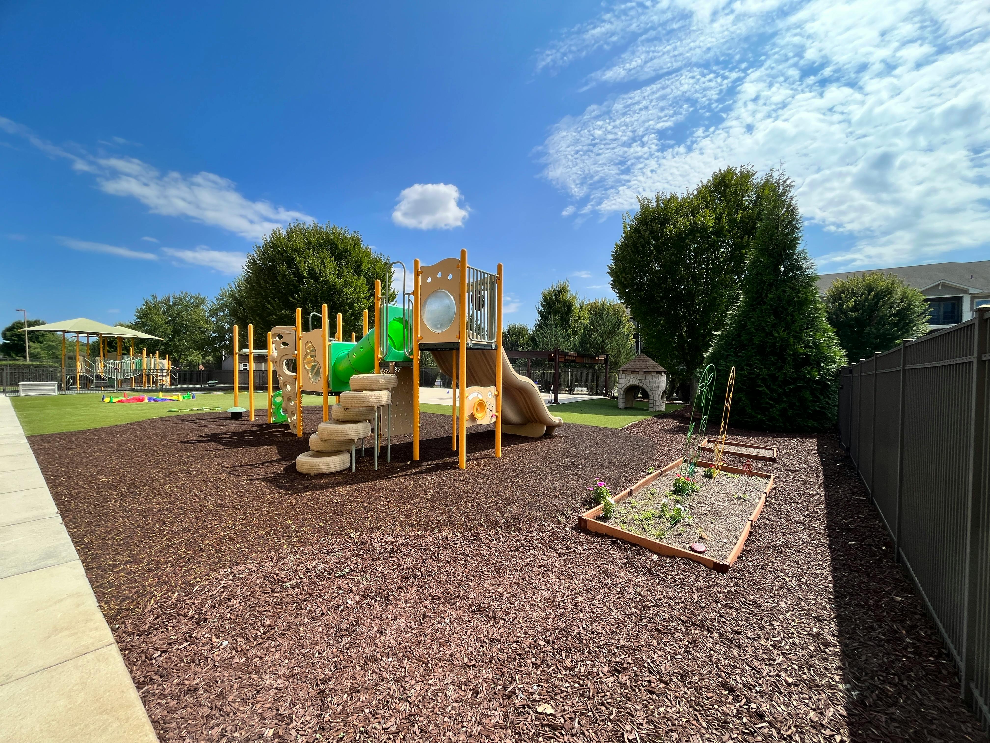 Playground with slides and climbing structures on wood chips