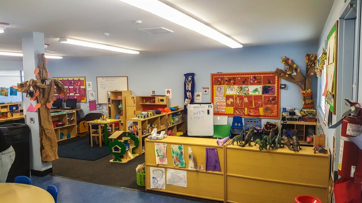 Classroom with shelves, tables, and decorations