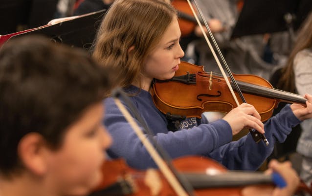 Teen playing a violin