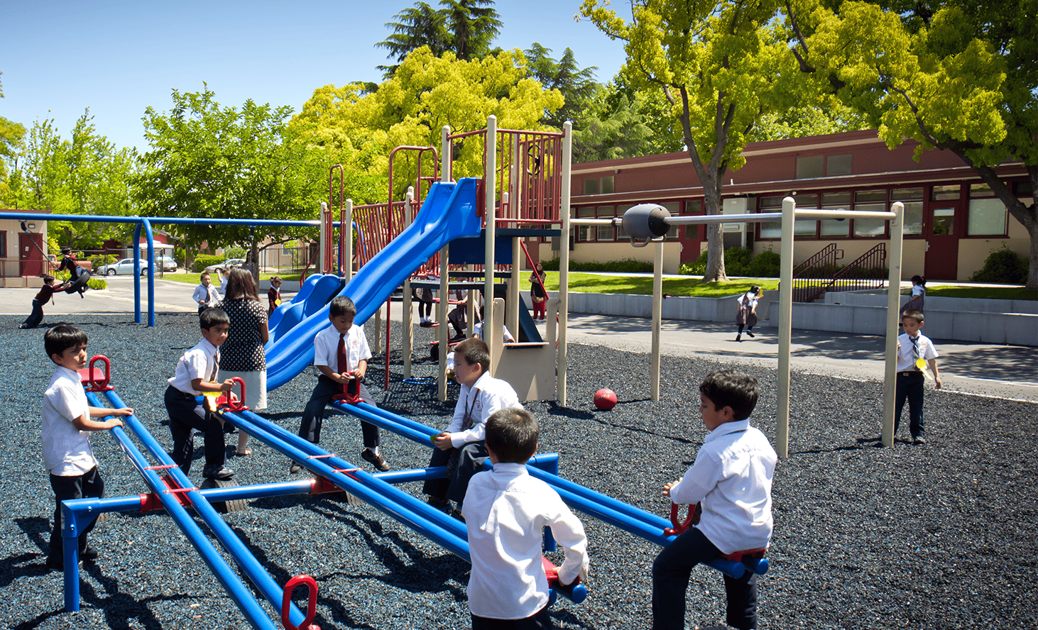 Children playing on seesaws and playground equipment