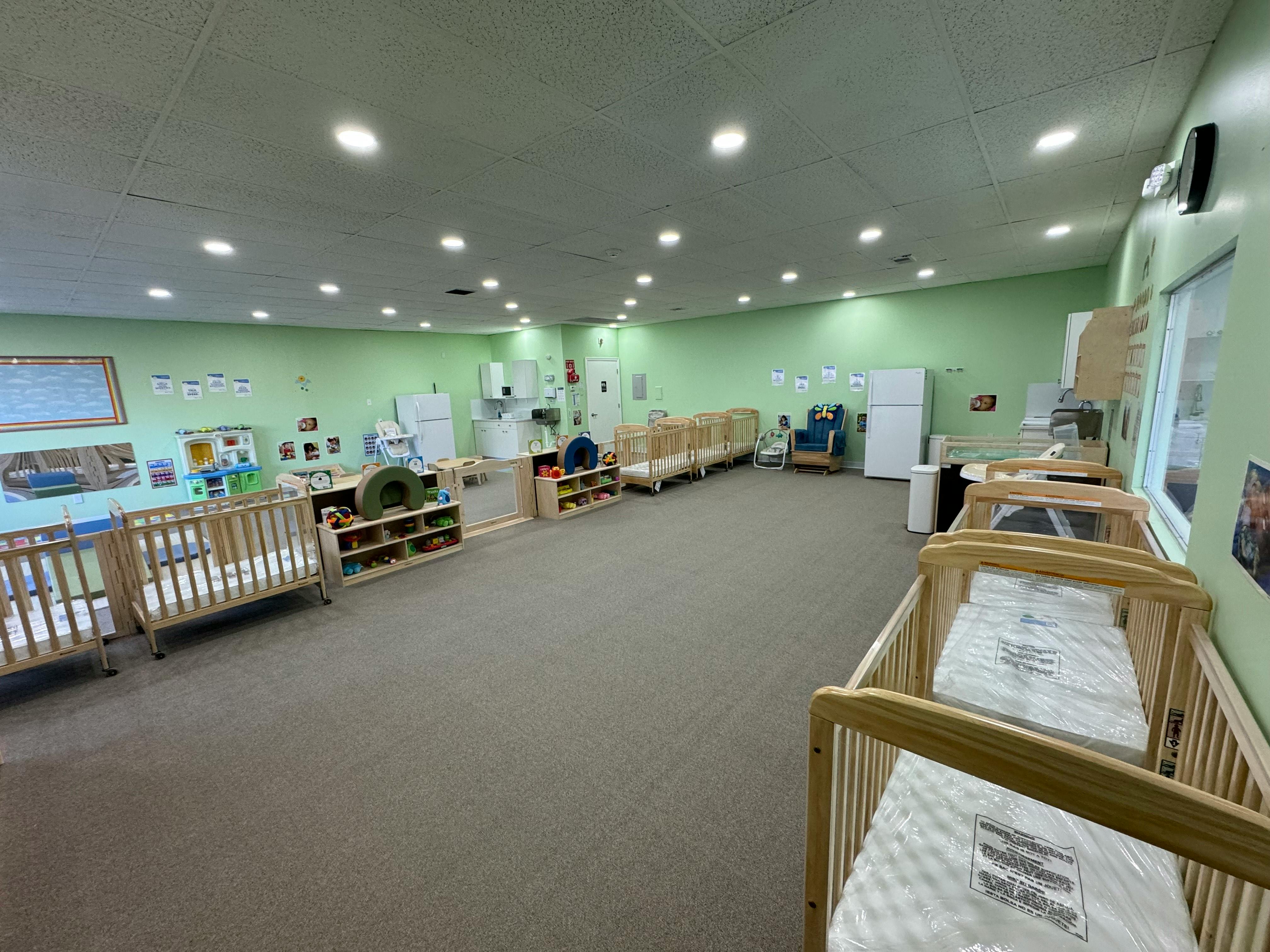 Cribs in a brightly lit daycare room