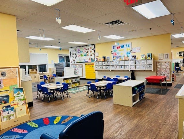 Empty classroom with small tables and chairs