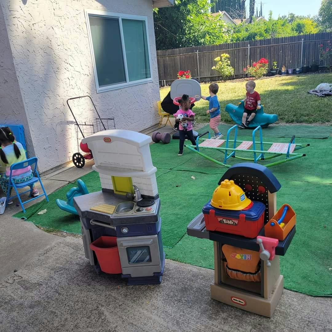 Children playing with toys in a backyard