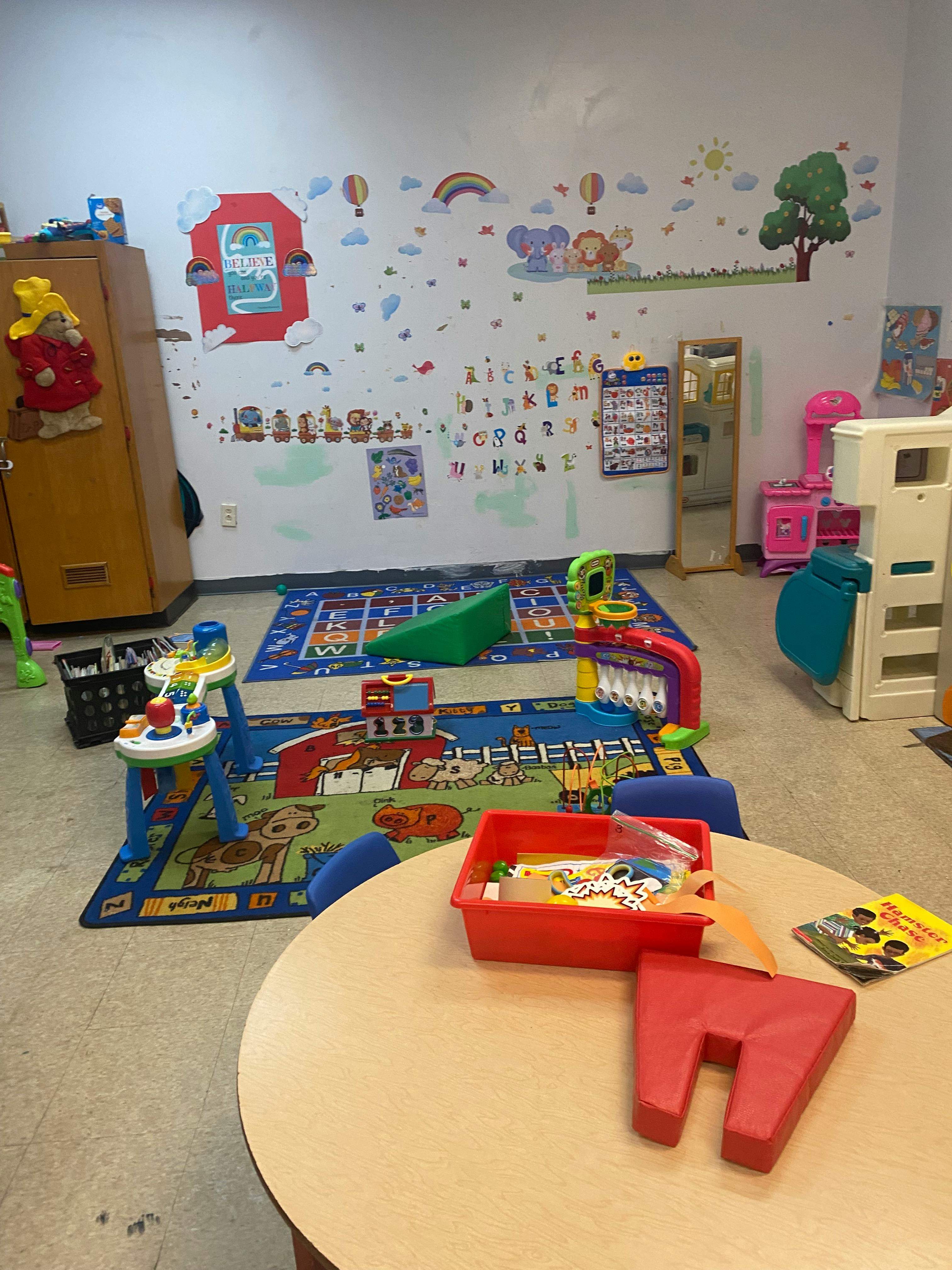 Playroom with colorful rugs, toys, and wall decals