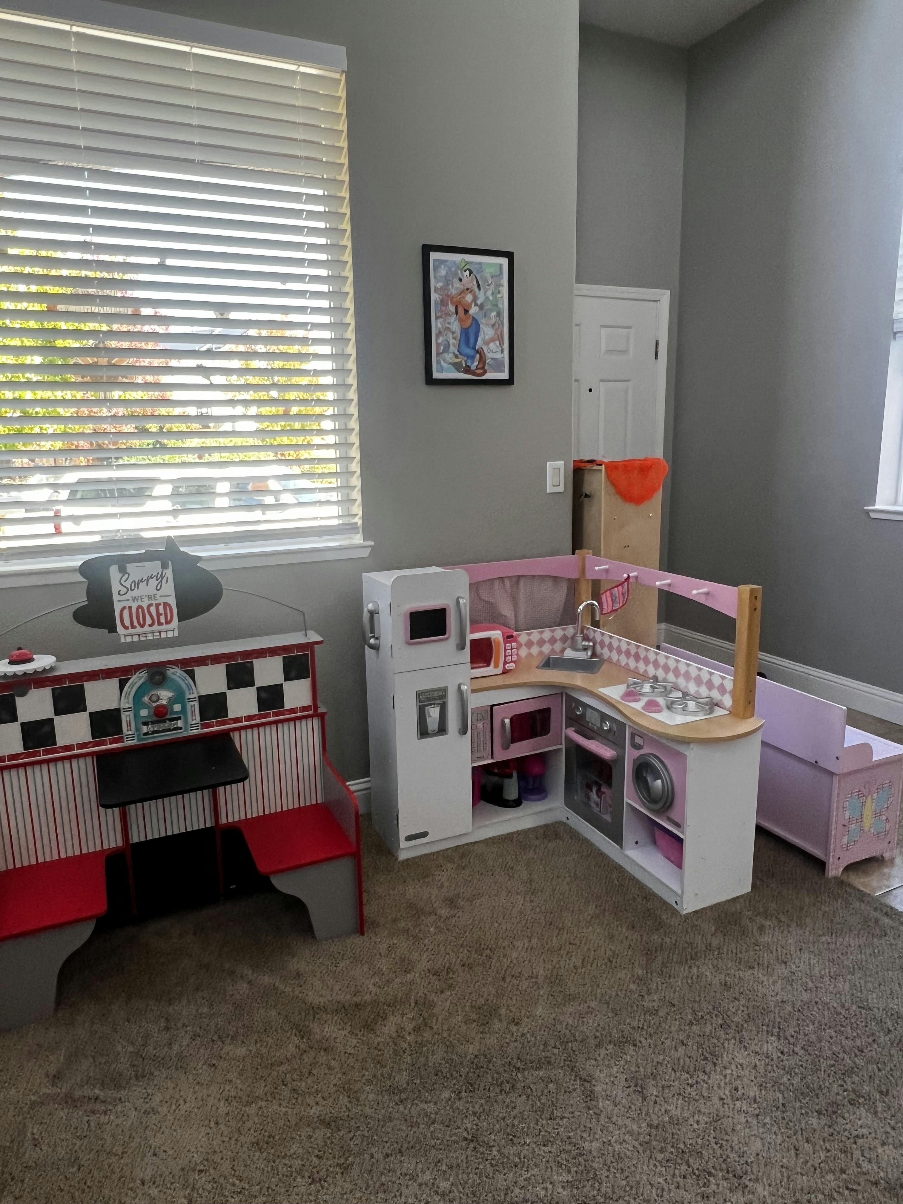 Child's play diner booth and kitchen set in a room