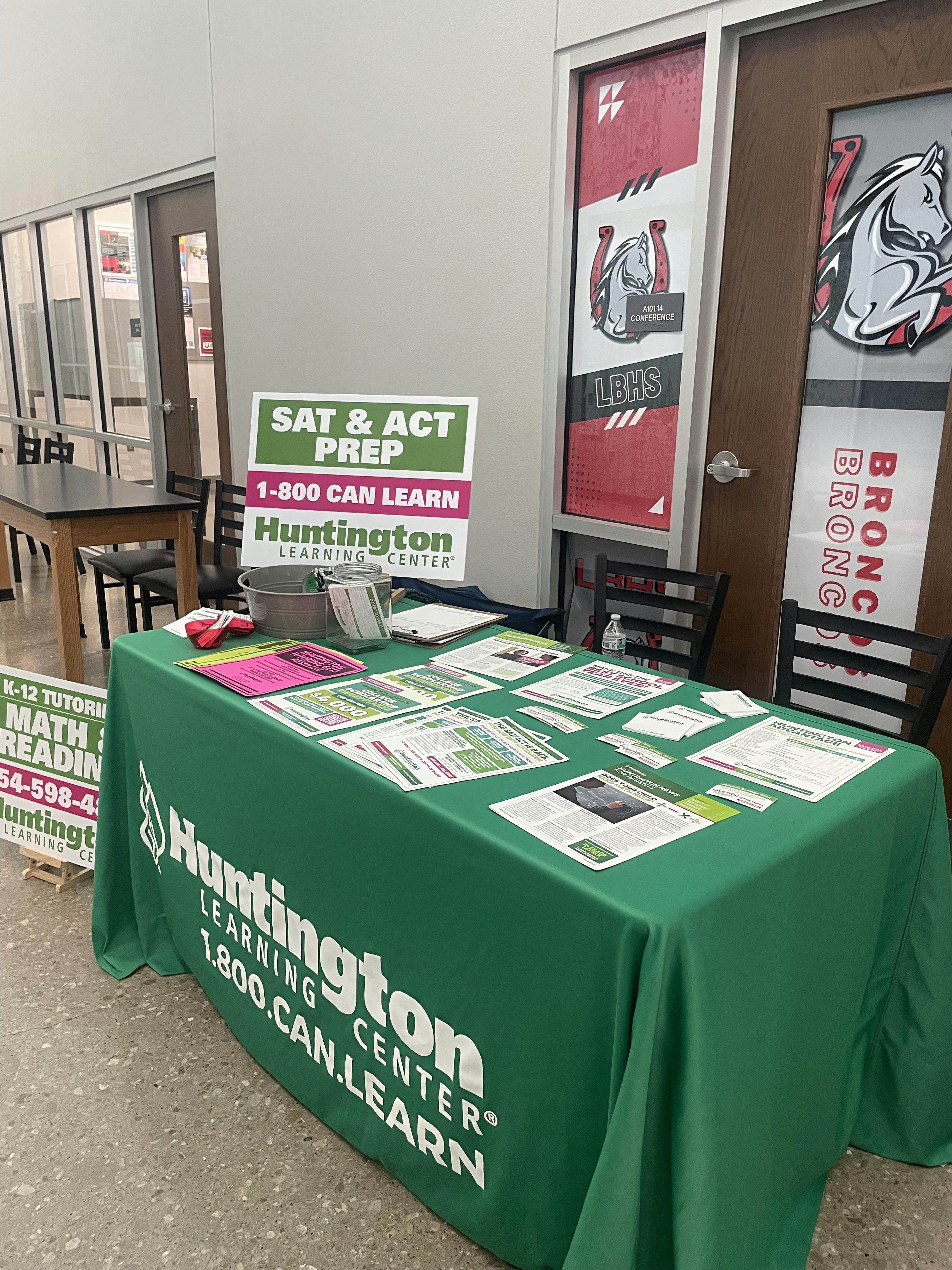 Huntington Learning Center informational table with pamphlets and prep signage