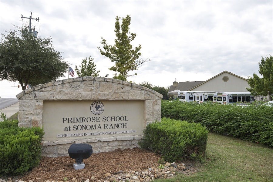 Stone sign for Primrose School at Sonoma Ranch with building in background