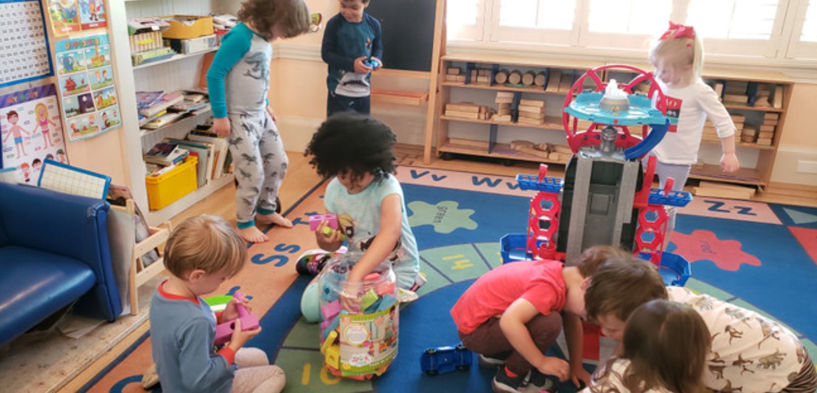 Children playing with toys in a classroom