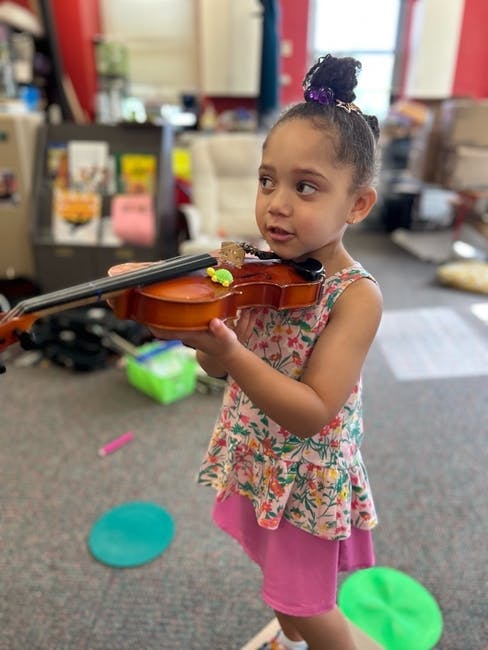 Child holding a violin