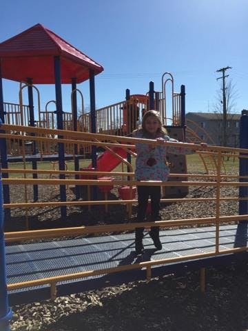 Child standing on a playground structure