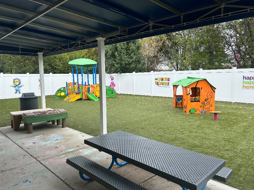 Outdoor playground with a picnic table in the foreground