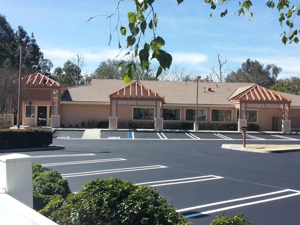 Building with two covered entrances and a parking lot