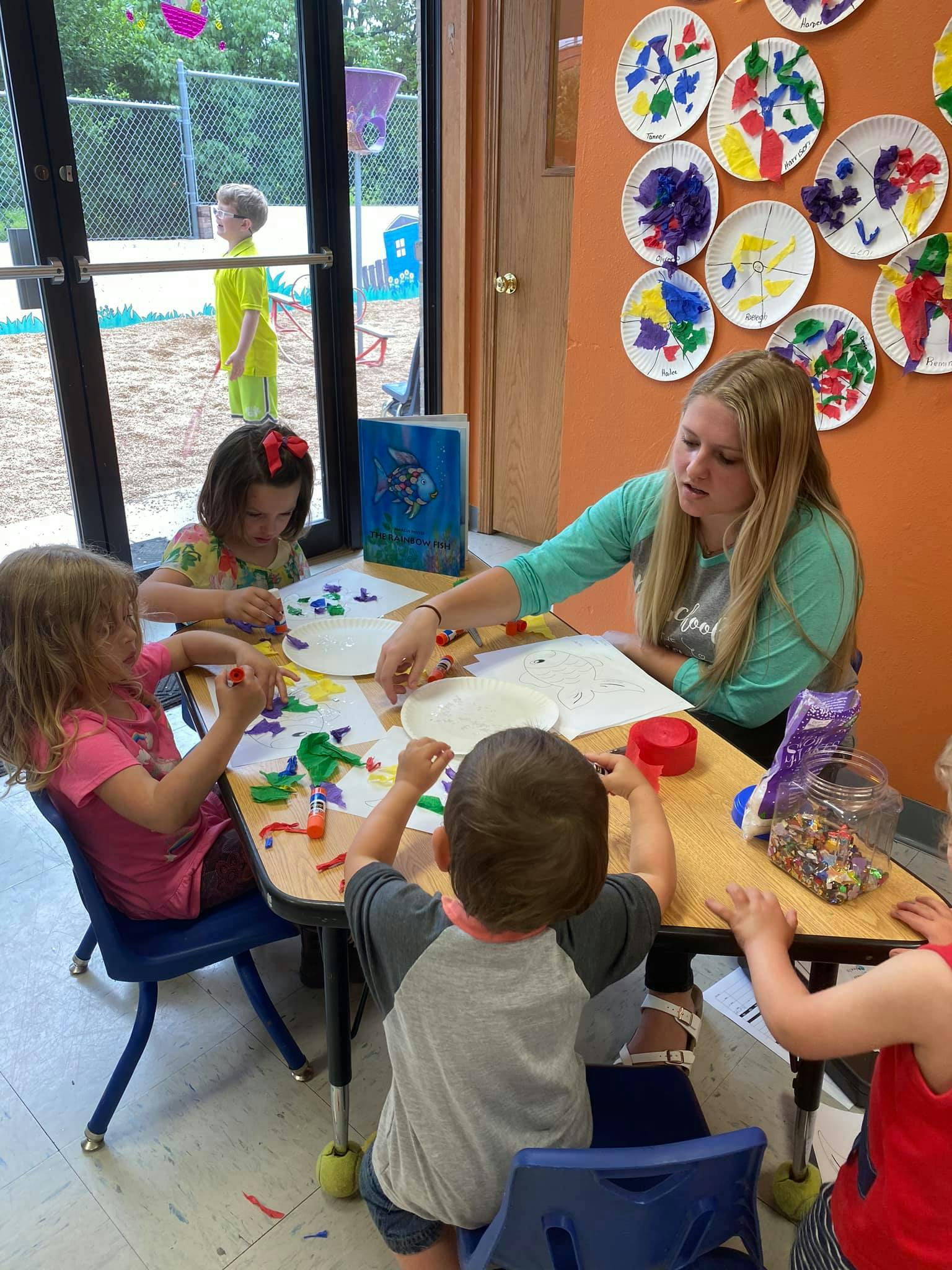 Adult and children doing crafts at a table