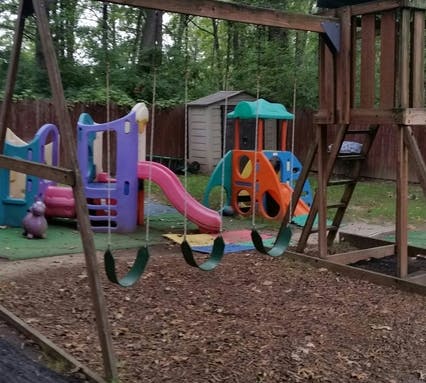 Outdoor playground with swings, slides, and climbing structures