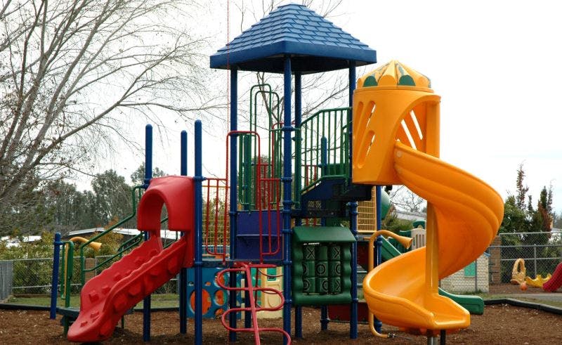 Playground structure with slides and climbing elements