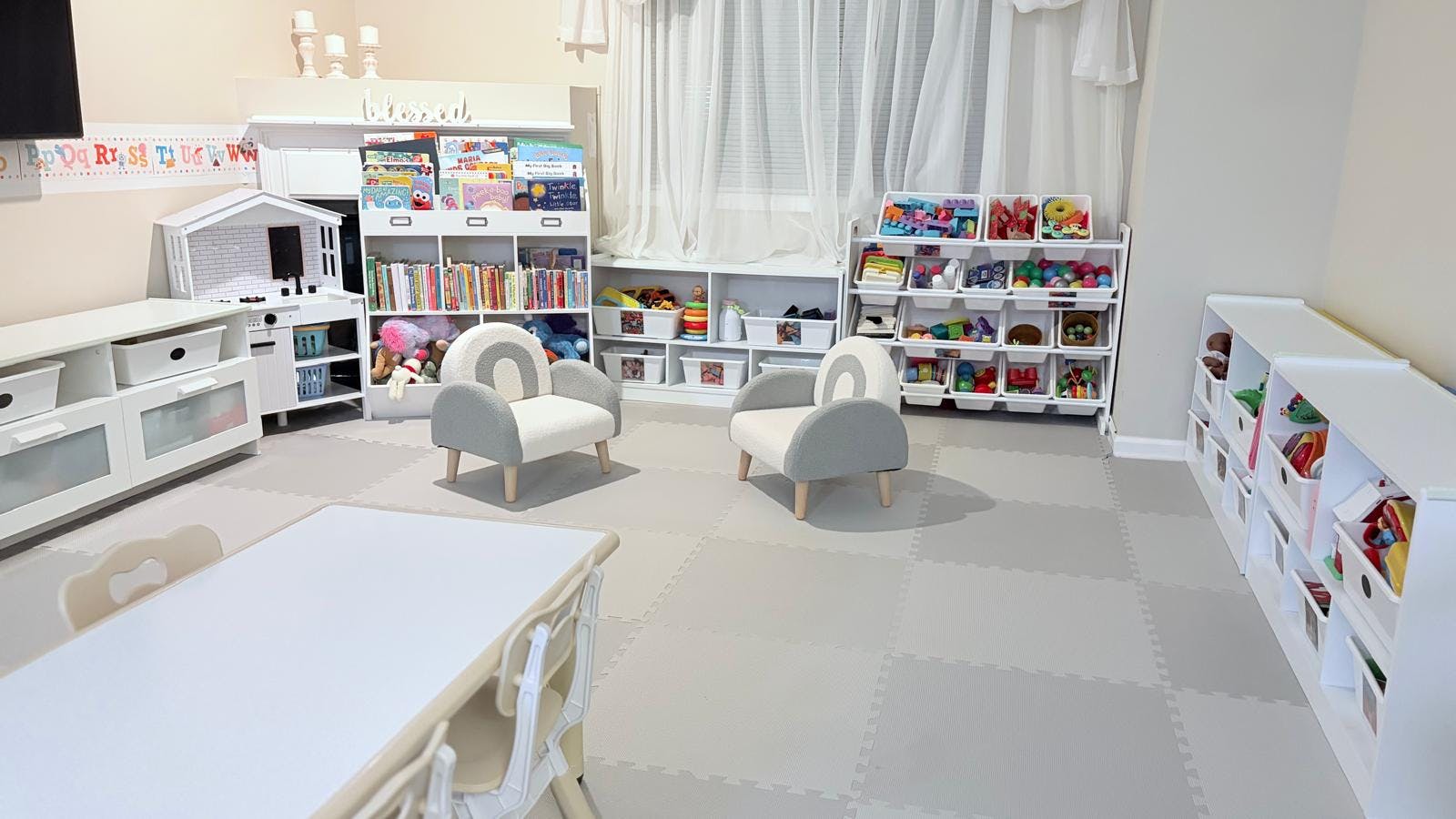 Playroom with toys, books, and child-sized furniture