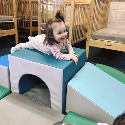 Child crawling on soft play equipment