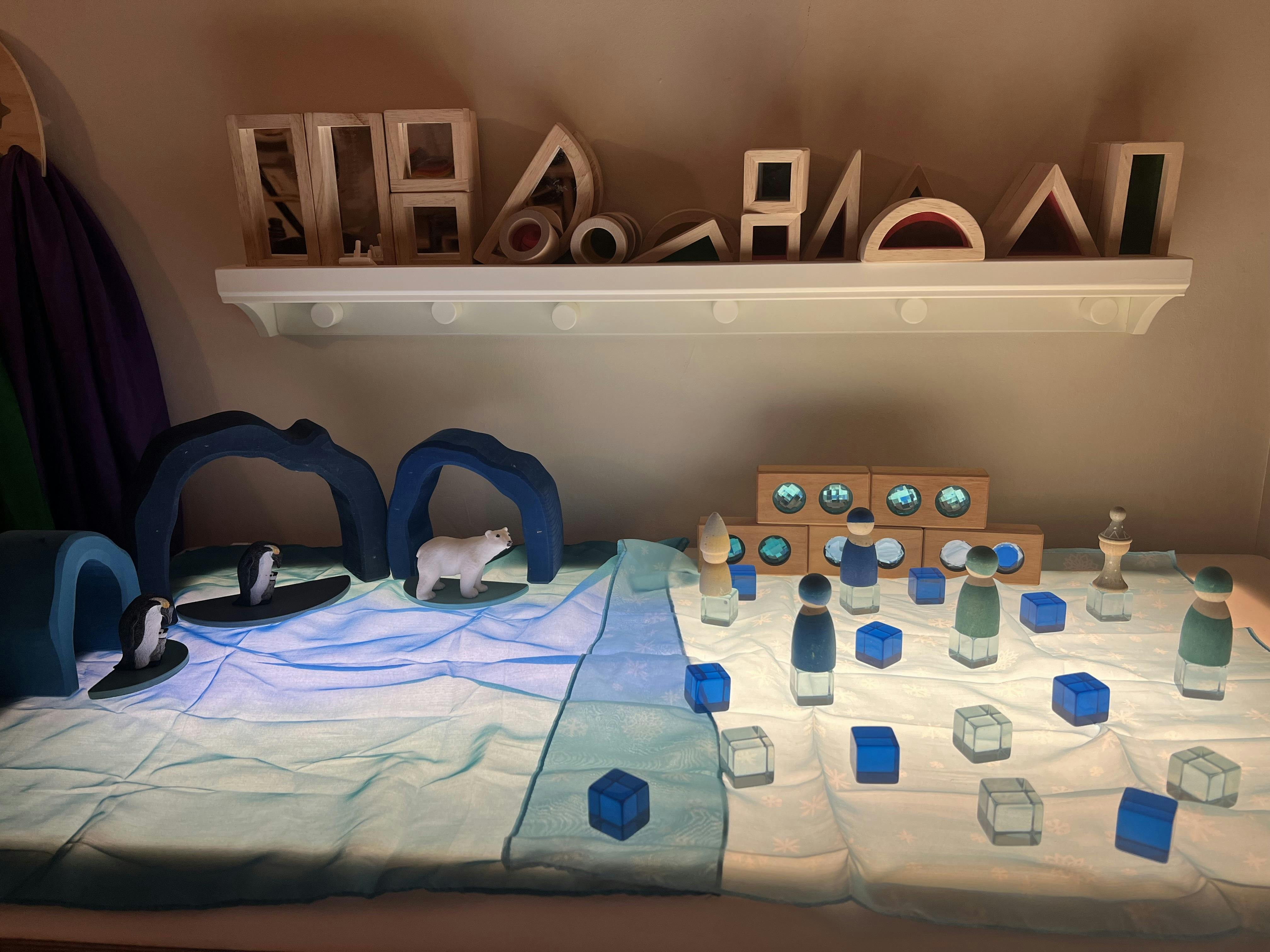 Small toy figurines arranged on a light-up play surface
