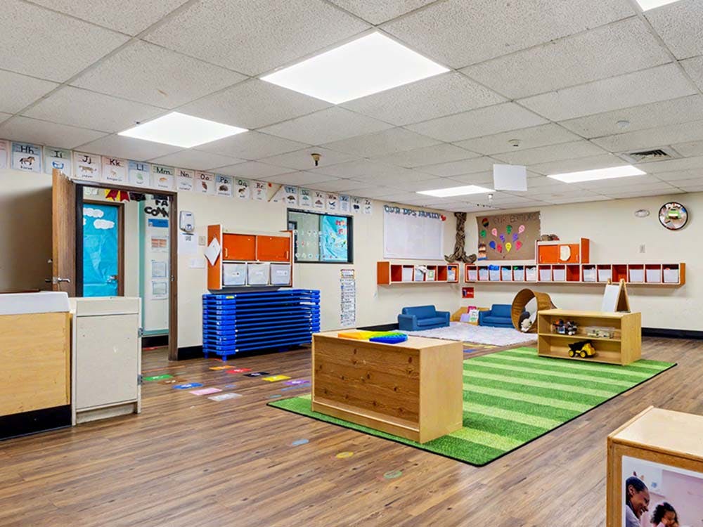 Empty classroom with alphabet letters on the wall and small furniture
