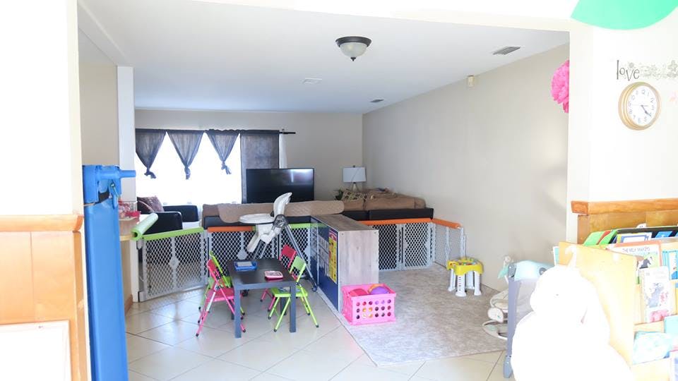 Living room with child gates, small table and chairs, and sofa