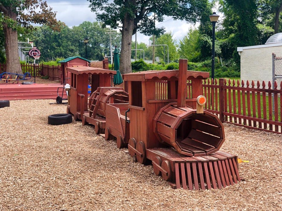 Wooden train playground equipment on wood chips