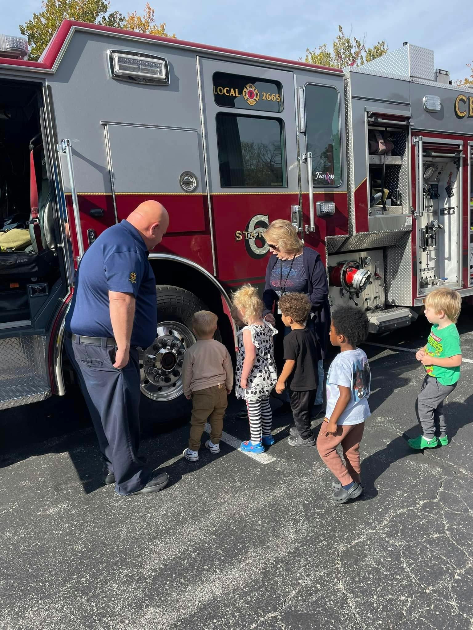Adults and children gathered around a fire truck
