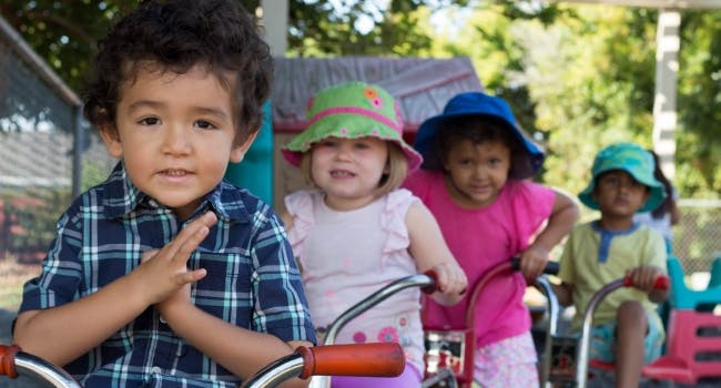 Four children on tricycles