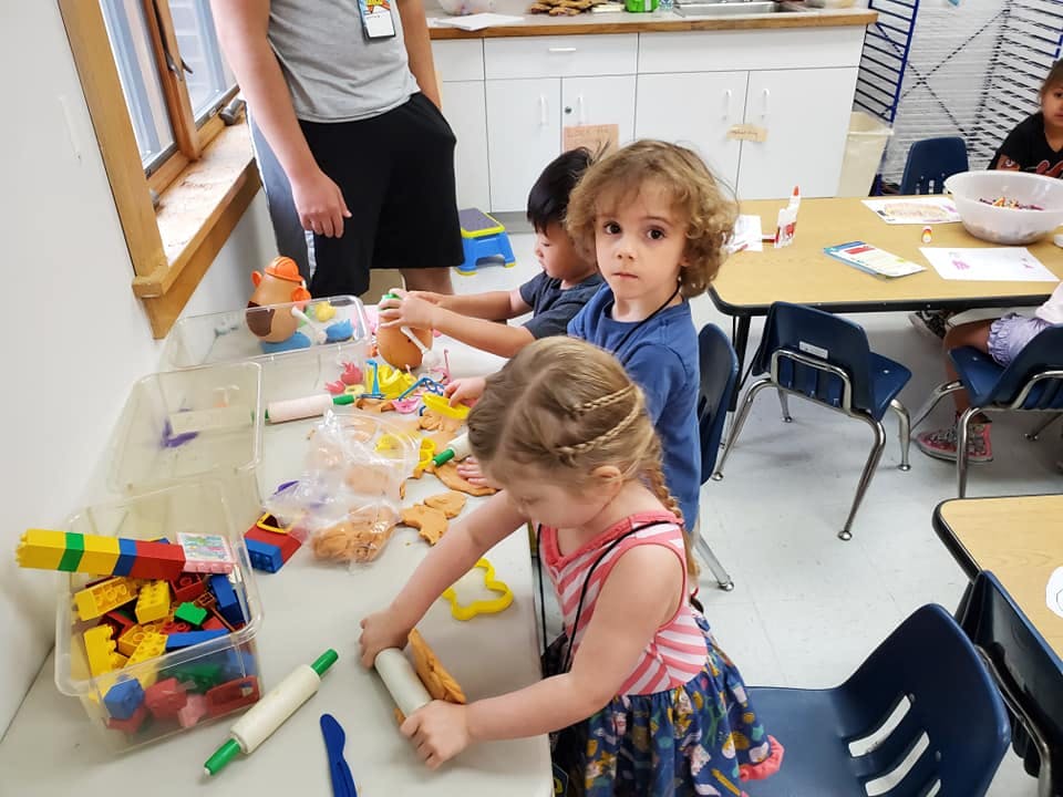 Children playing with toys at a table