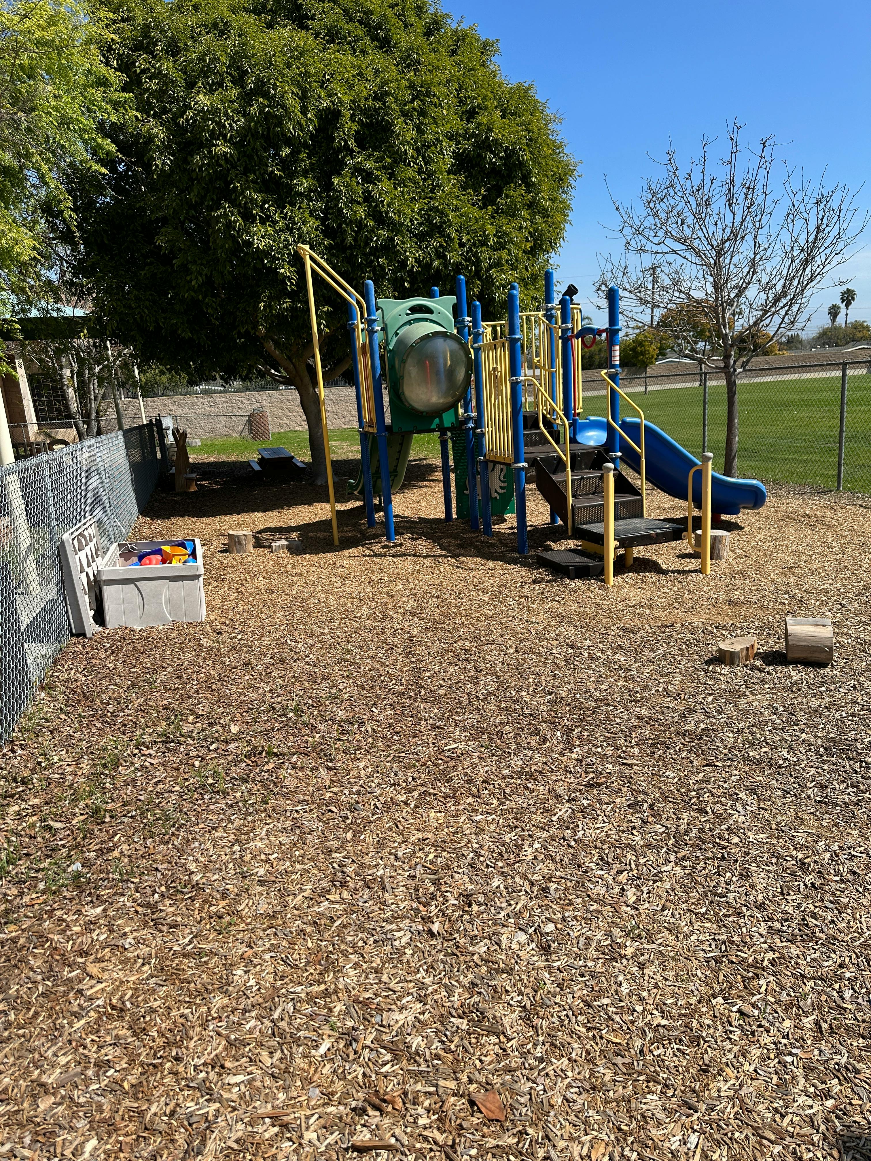 Playground with slides and climbing structures on wood chips