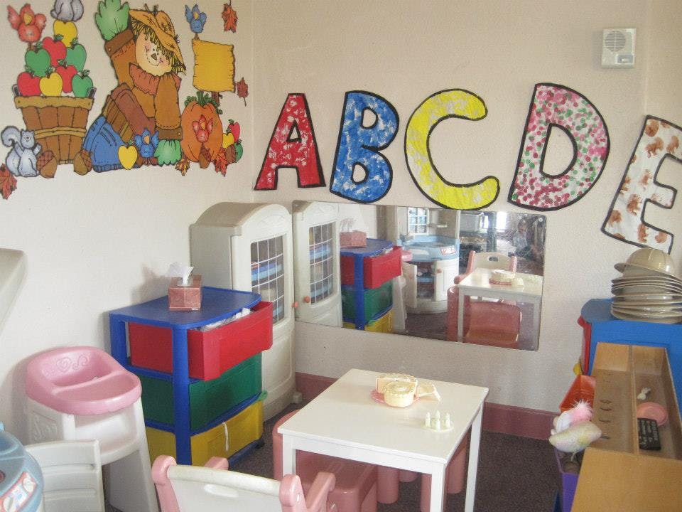 Classroom with ABC letters on the wall and small tables and chairs