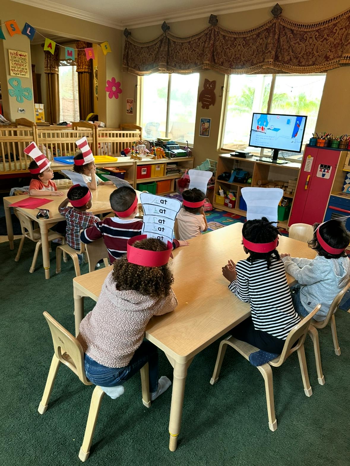 Children sitting at tables in a classroom