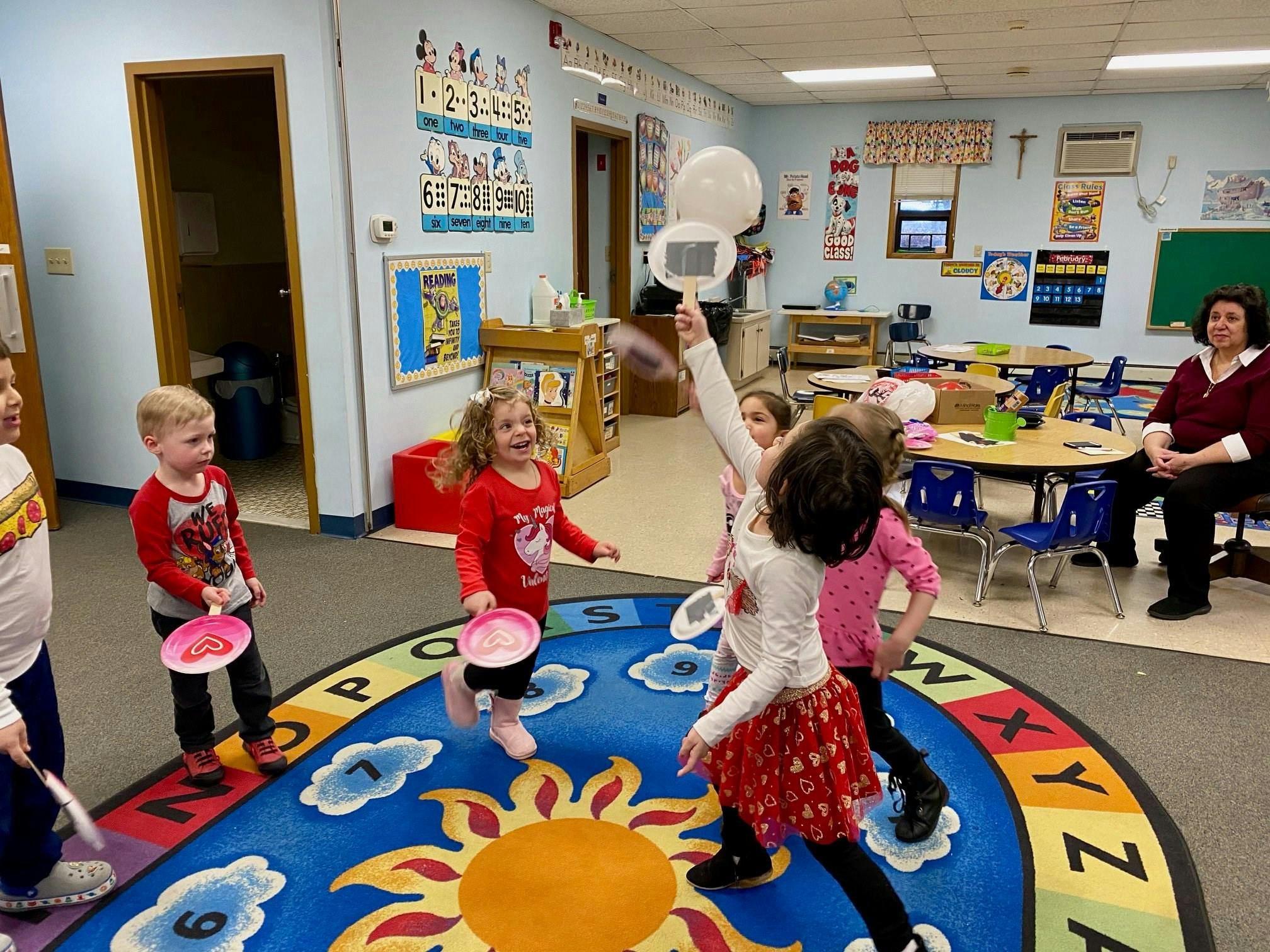 Children playing with bubbles in a classroom
