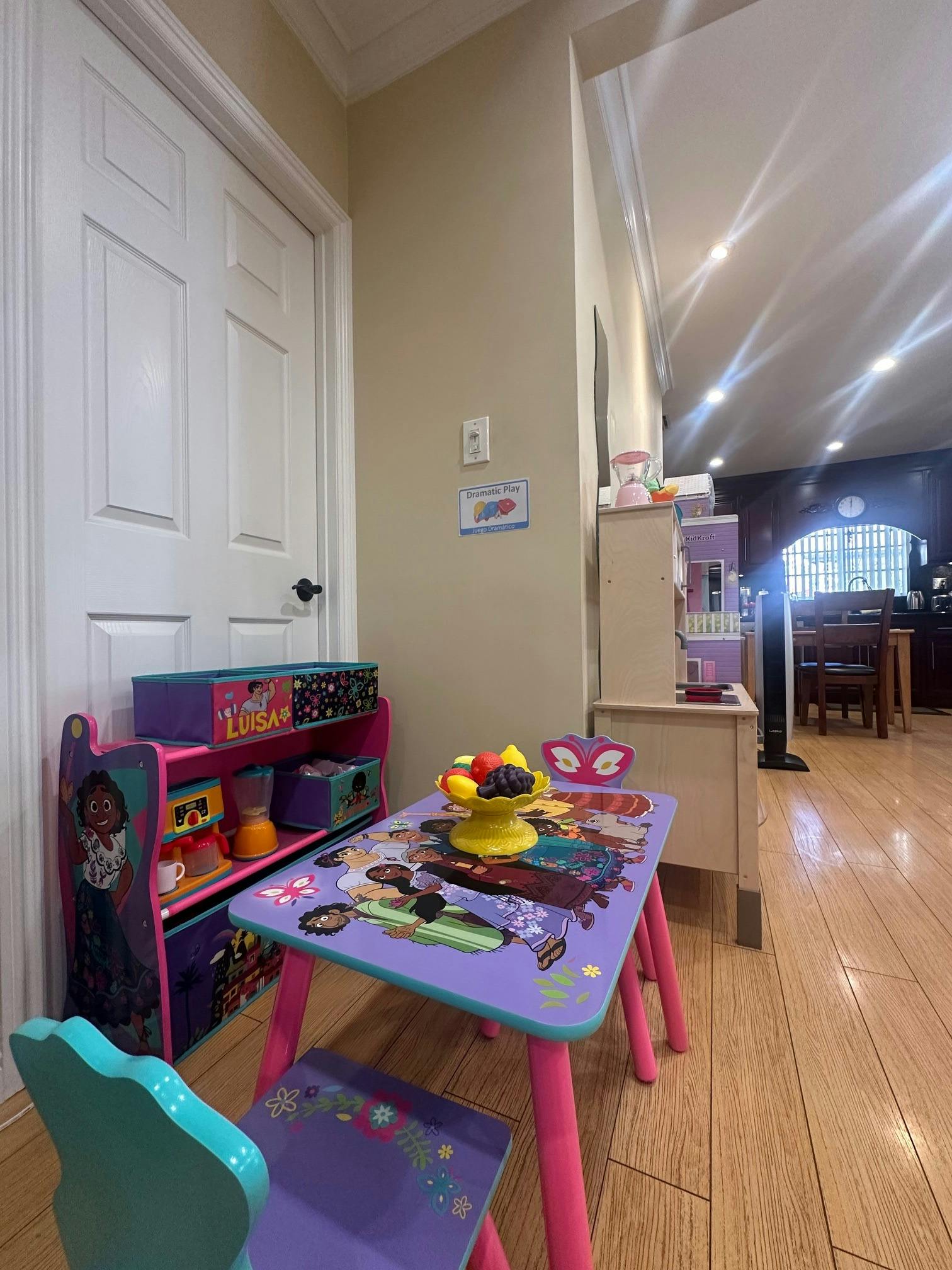 Child's table and chair set with a toy fruit bowl