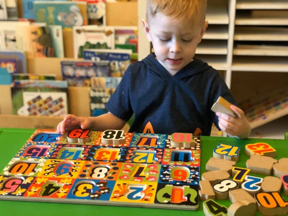 Child playing with a number puzzle