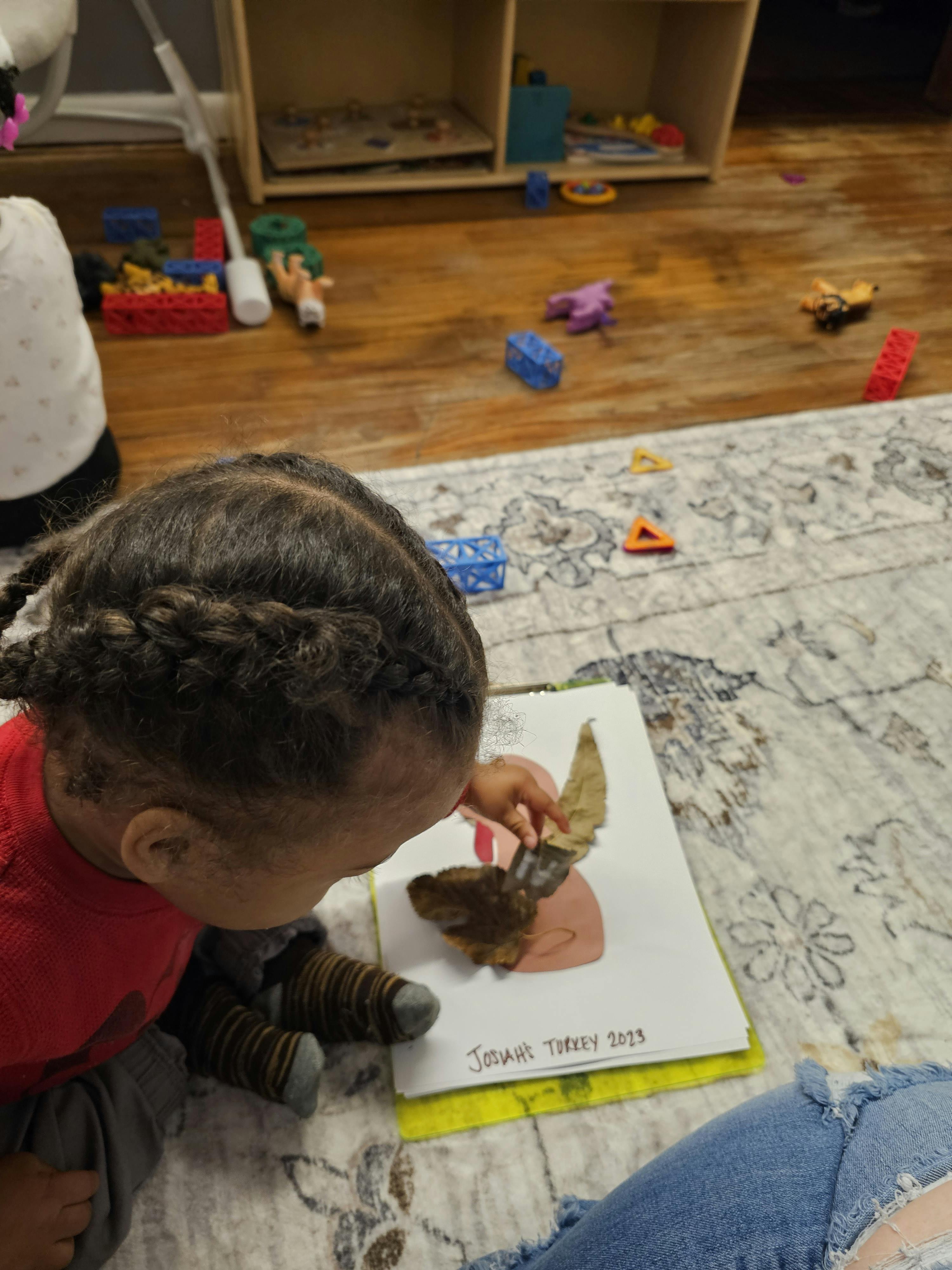 Child looking at a drawing of a turkey