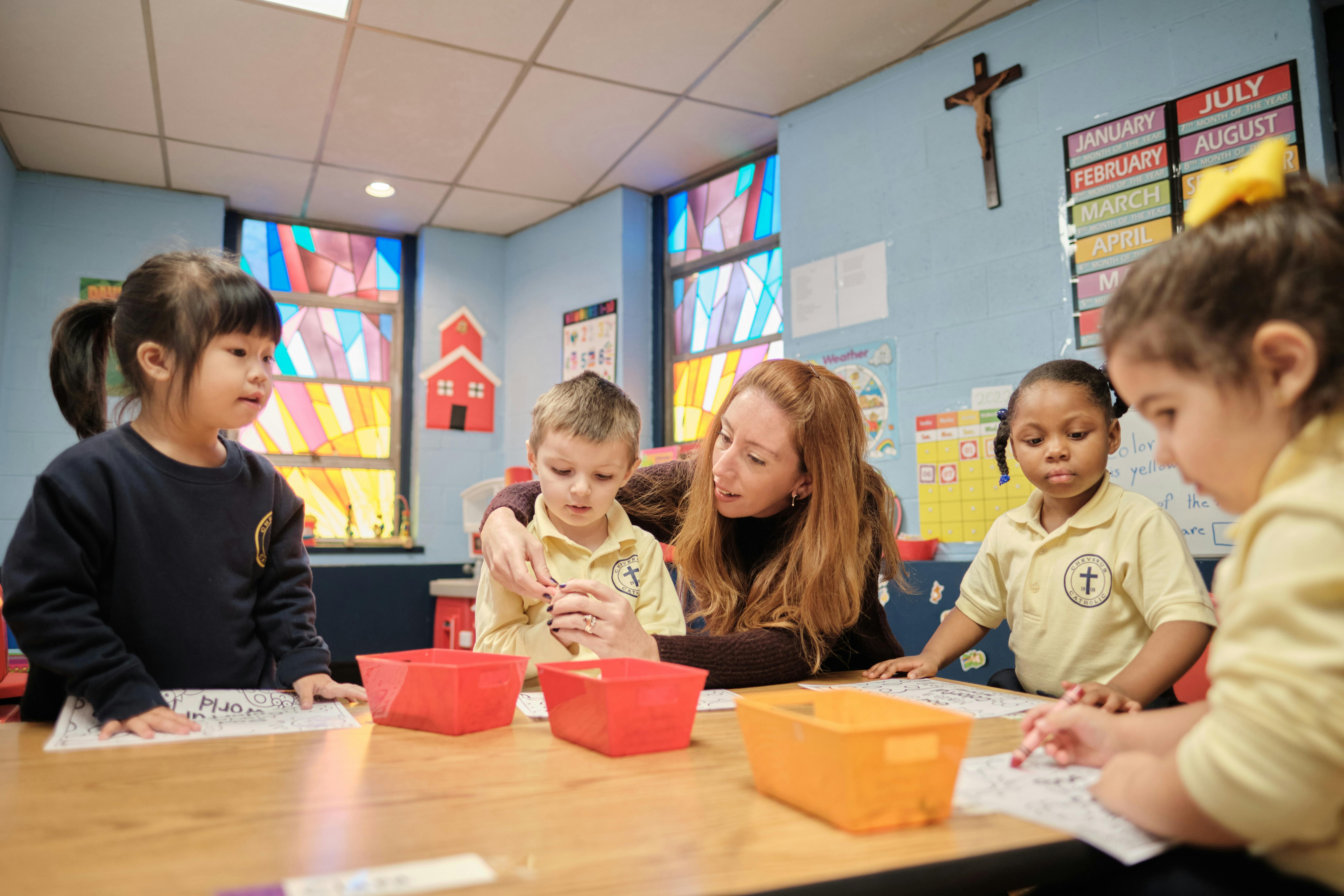 Adult and children at a table in a classroom