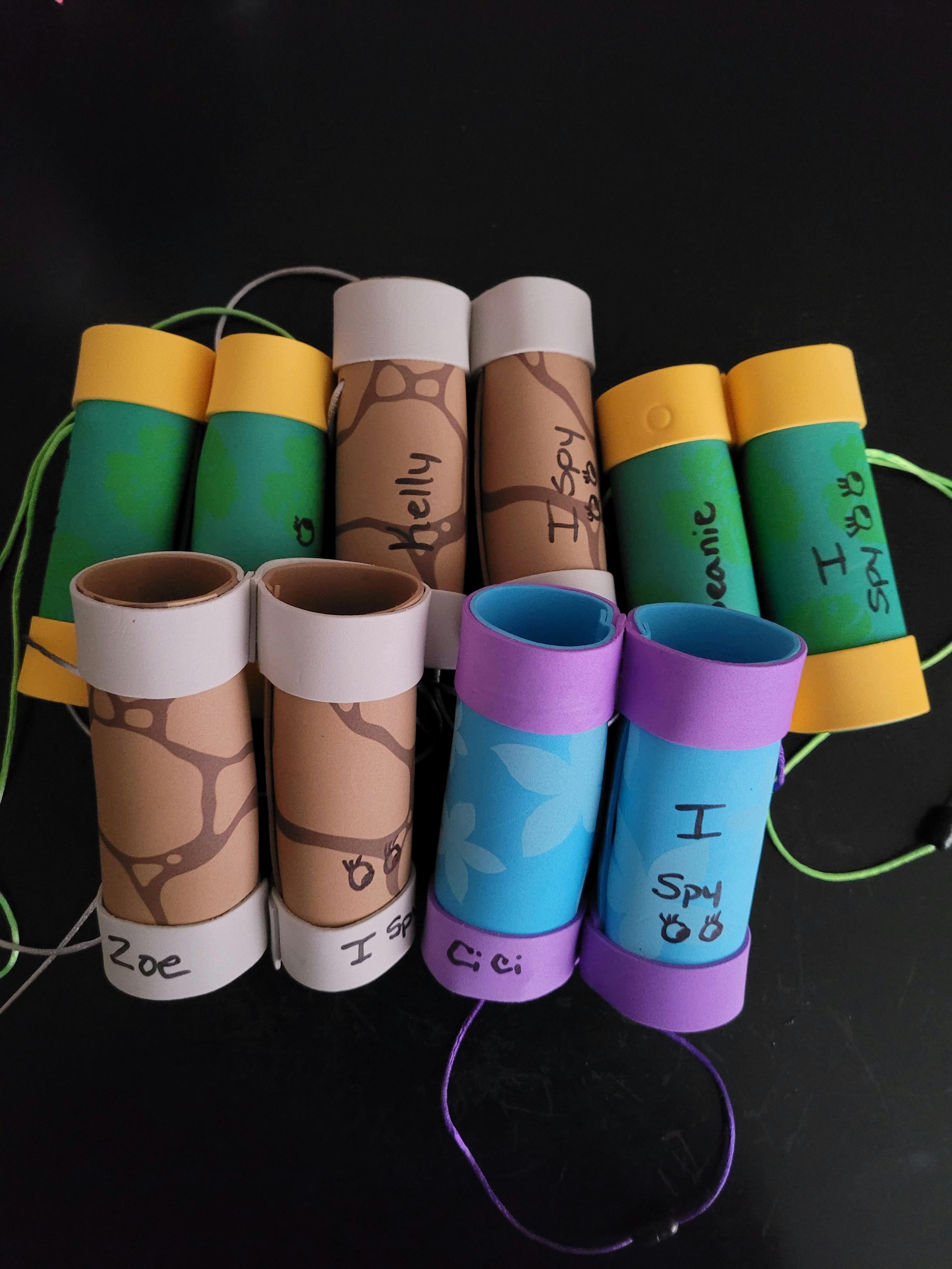 Craft binoculars made from cardboard tubes, some with "I Spy" written on them