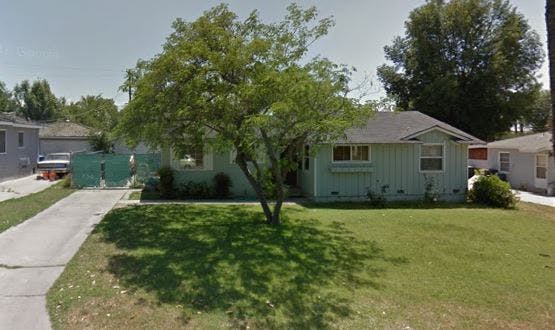 House with a tree in the front yard