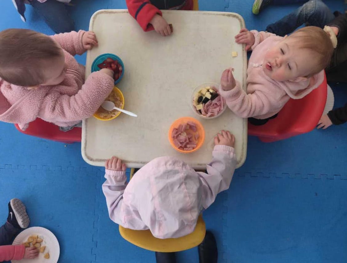 Children eating snacks at a small table