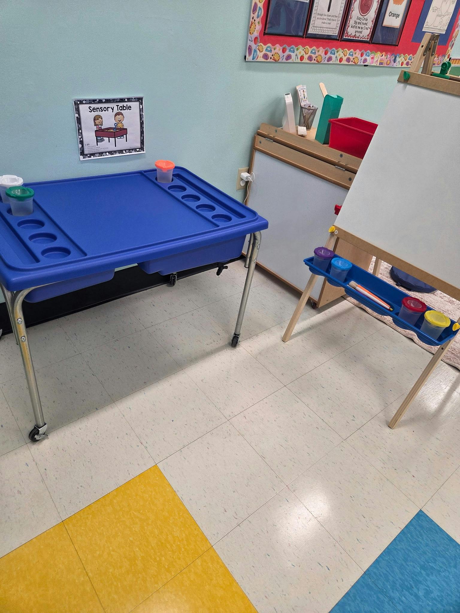 Sensory table and art easel in a classroom