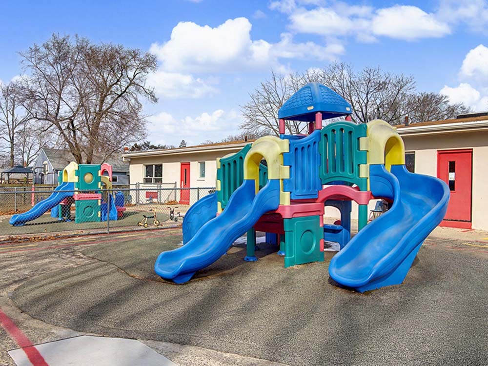 Colorful playground structure with slides and a climbing area