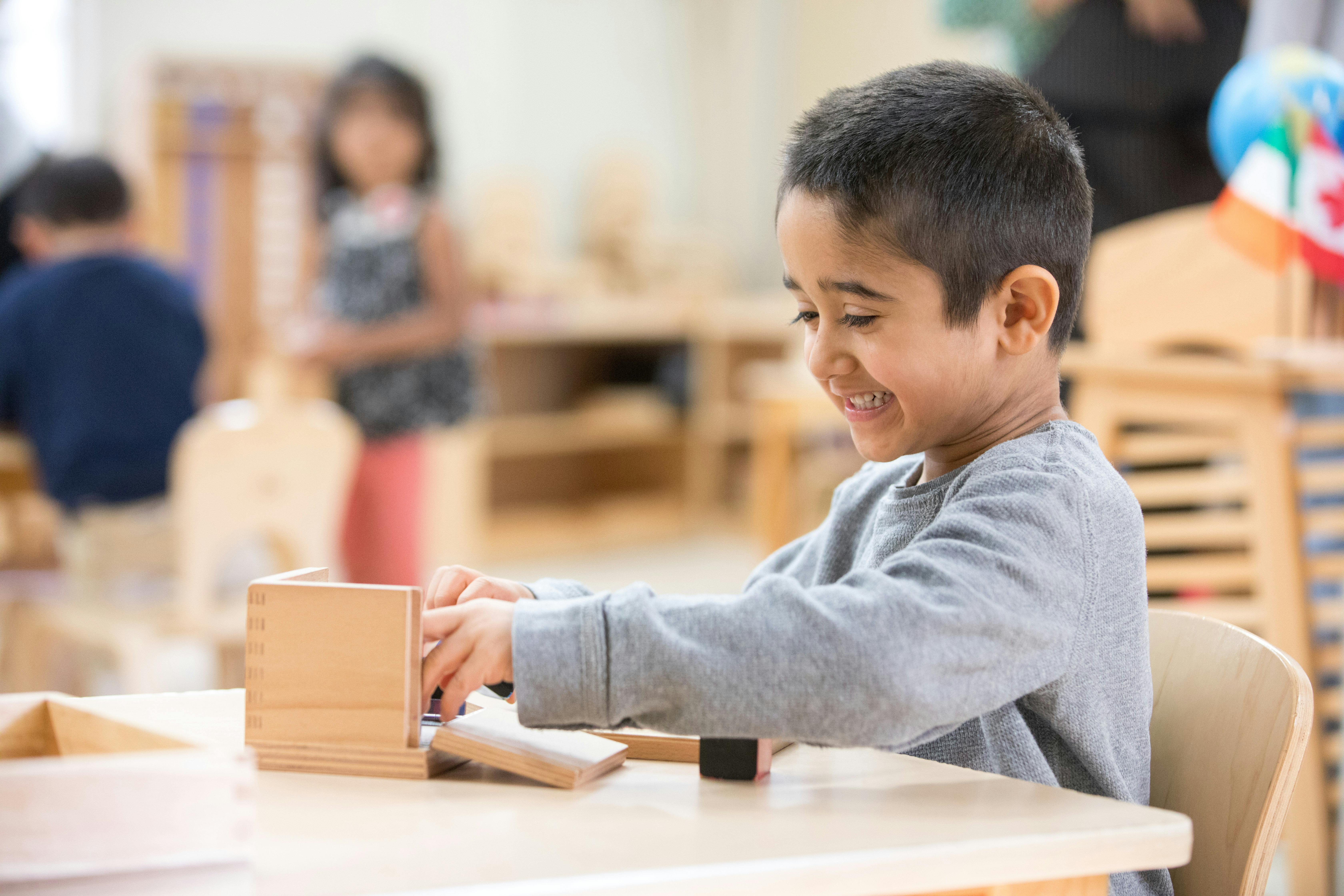 Child playing with wooden blocks at a table