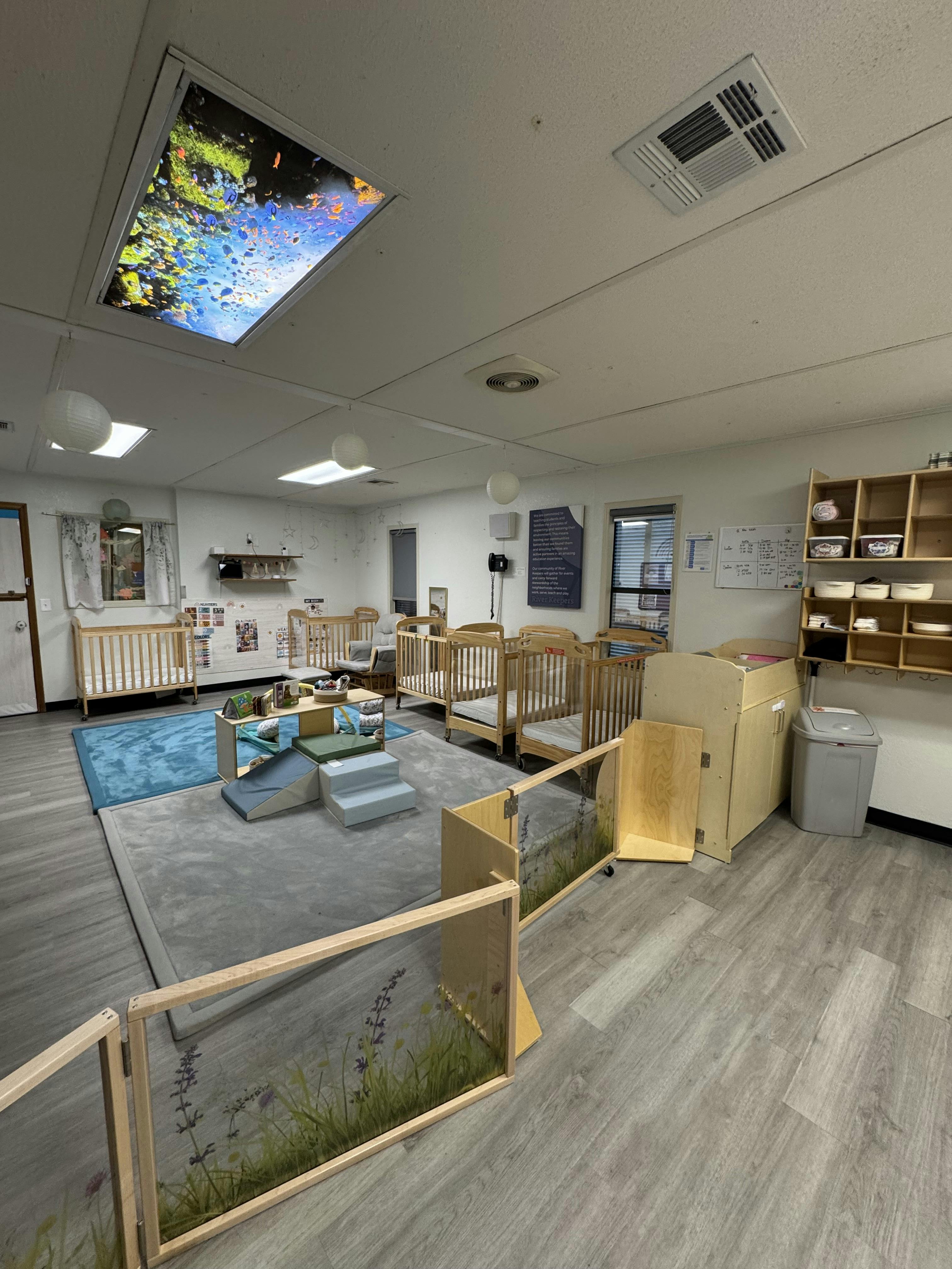 Cribs and play mats in a classroom