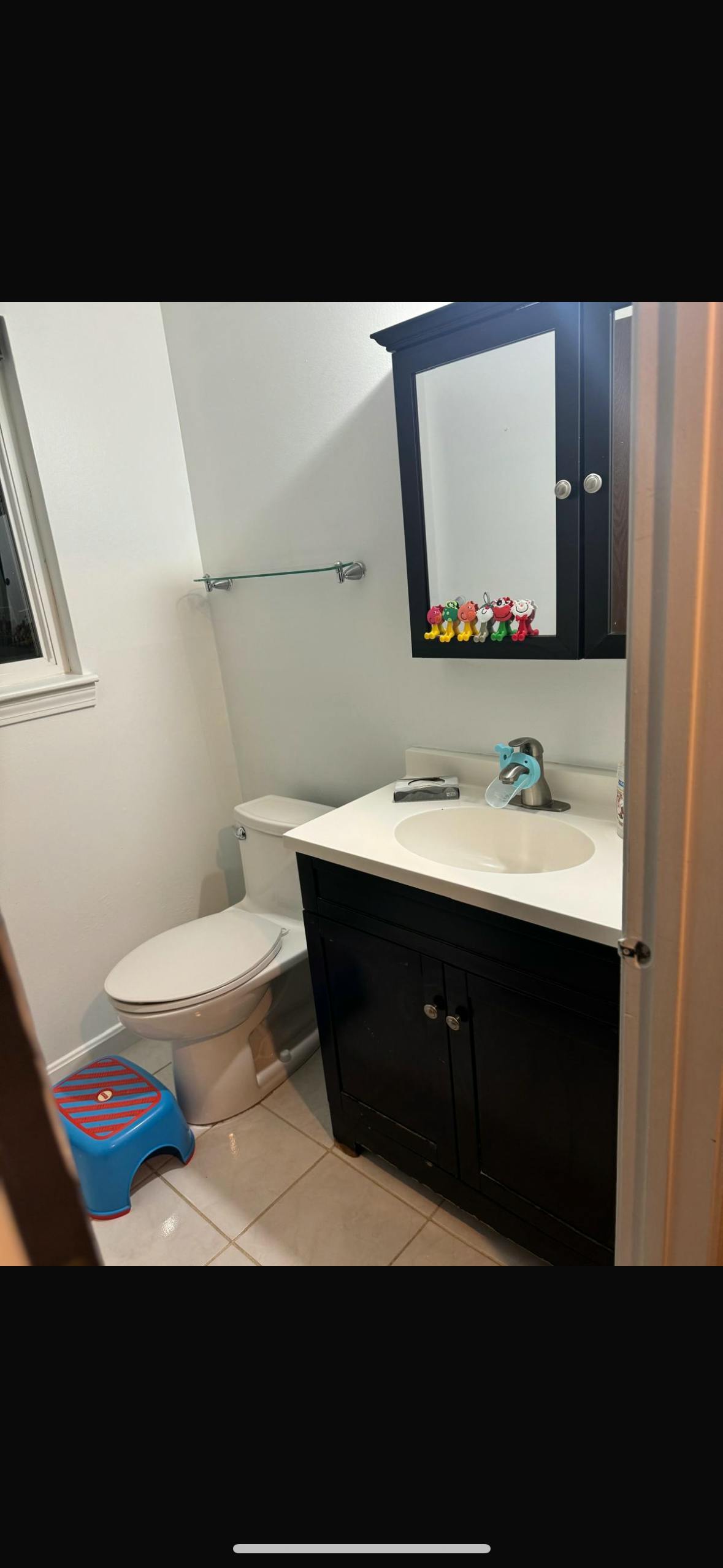 Bathroom with toilet, sink, and vanity