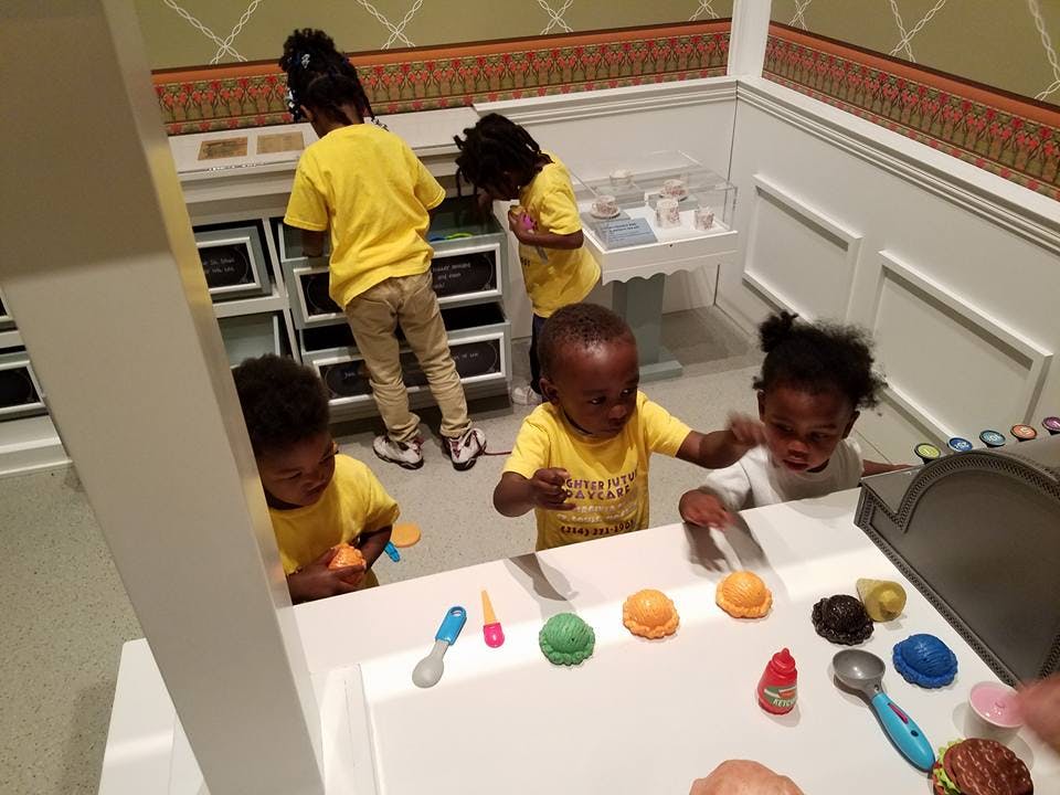 Children playing with toys at a table
