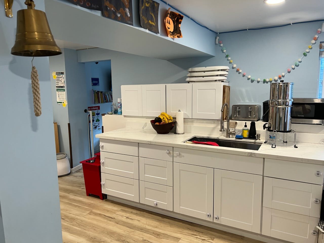 Kitchen counter with white cabinets and a sink
