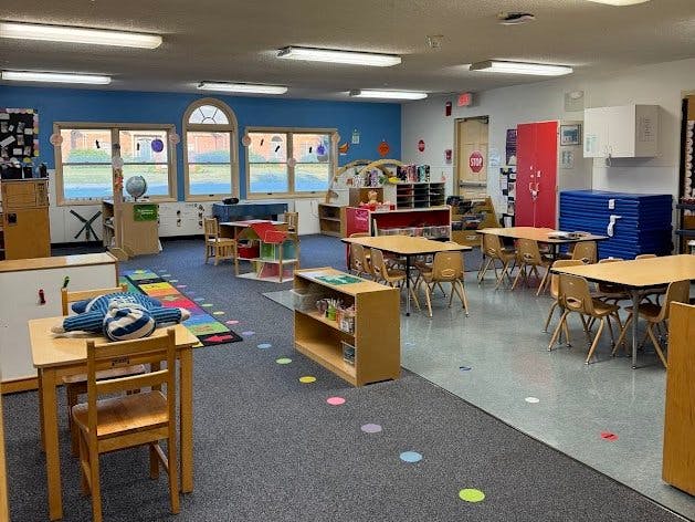 Empty classroom with small tables and chairs