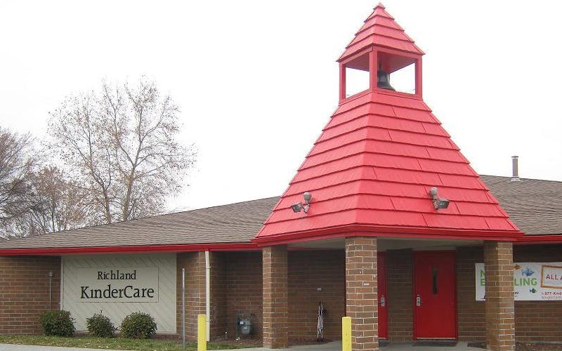Richland KinderCare building with a red roof and bell tower