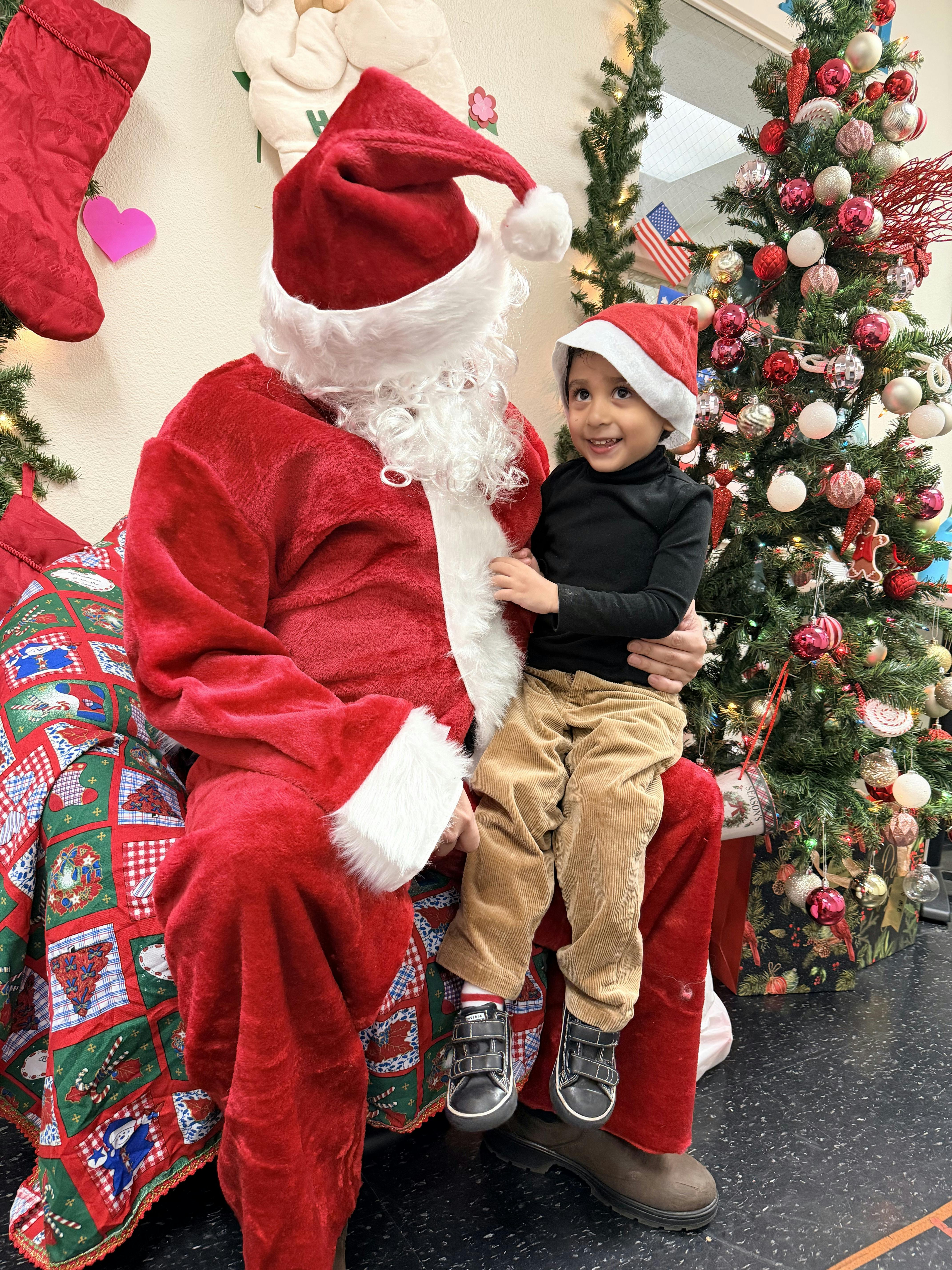 Person dressed as Santa Claus holding a child on their lap